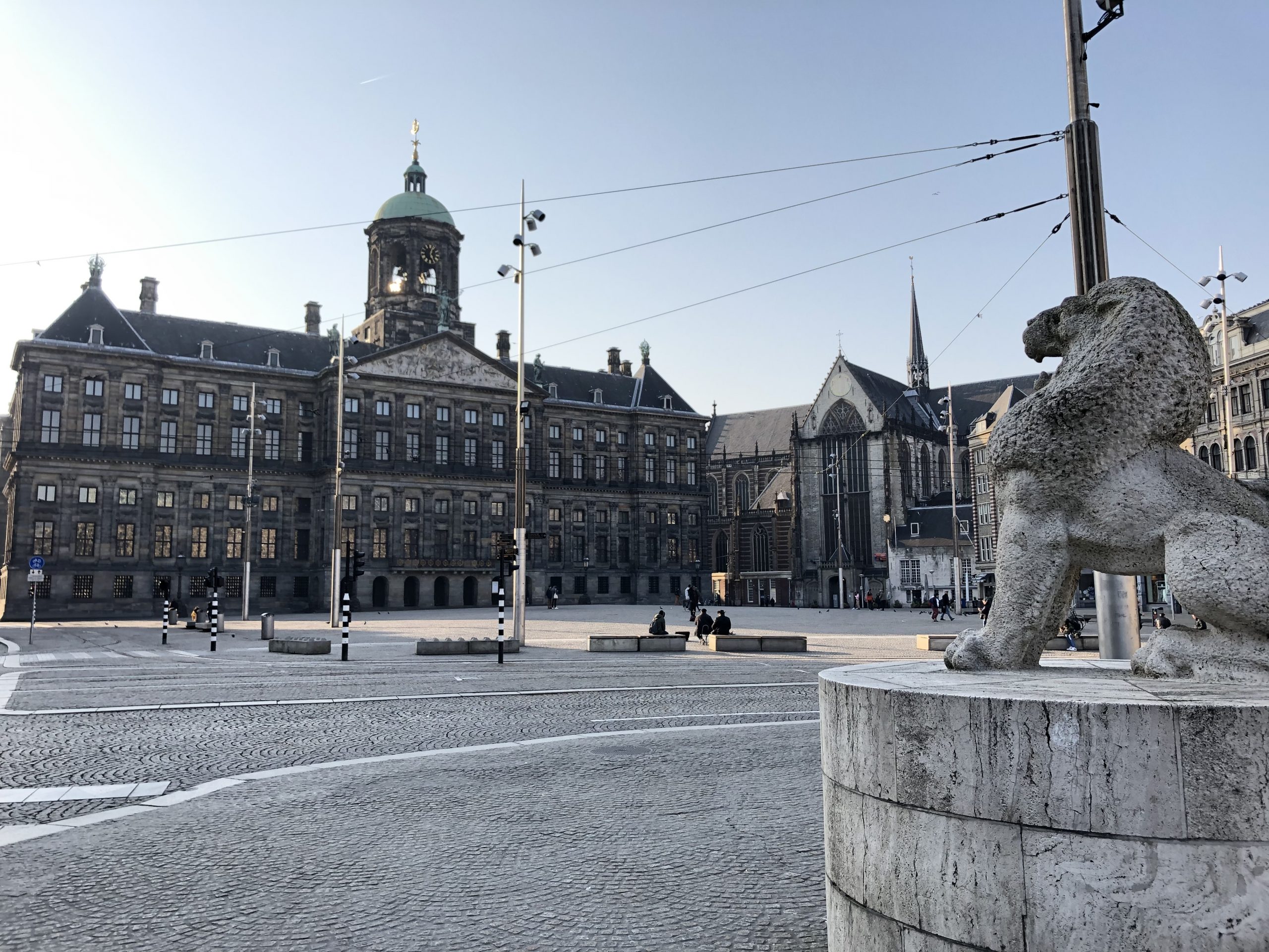 "File:Corona - Empty streets in Amsterdam - Dam met Paleis.jpg" by Hay Kranen is licensed under CC BY 4.0